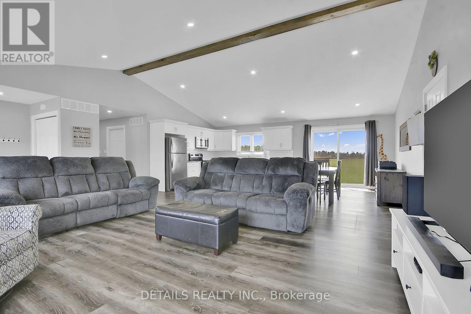 Vaulted ceiling with wood beam accent.