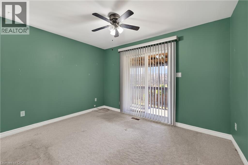 Unfurnished room featuring carpet and a ceiling fan