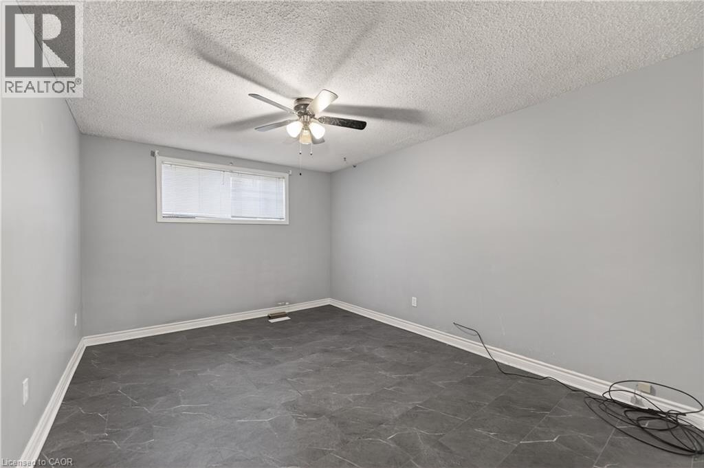 Spare room featuring a textured ceiling and a ceiling fan