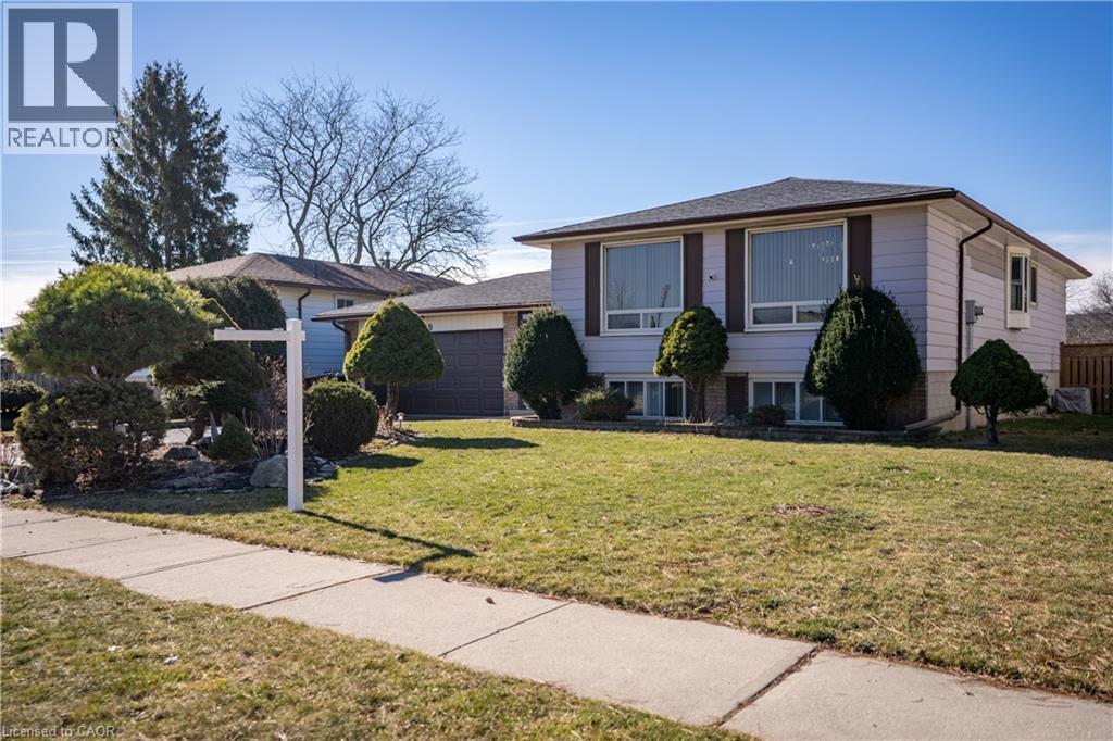 View of front of house with a garage and a front yard