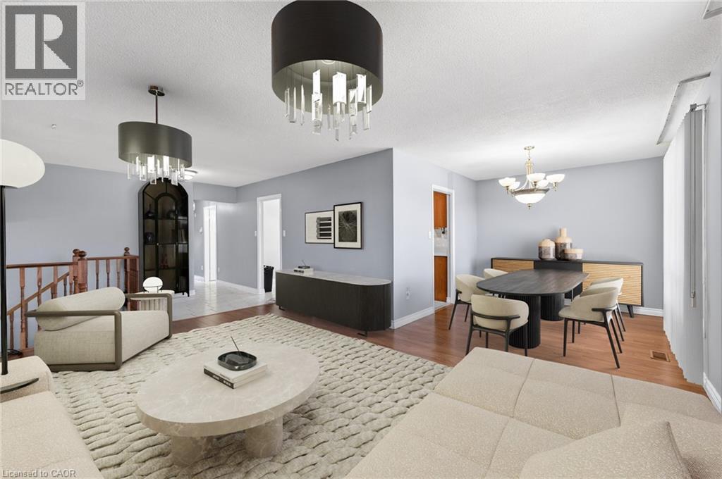 Living area featuring suspended lighting, wood finished floors, and a textured ceiling