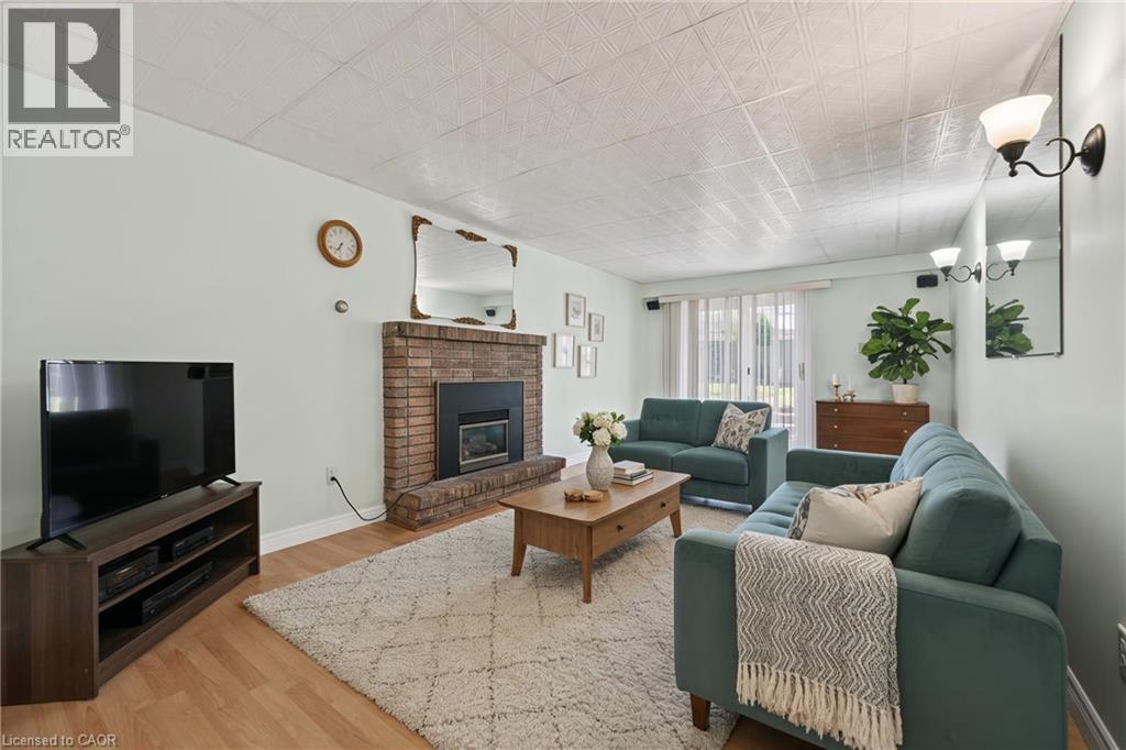Living room featuring light wood-style flooring and a fireplace