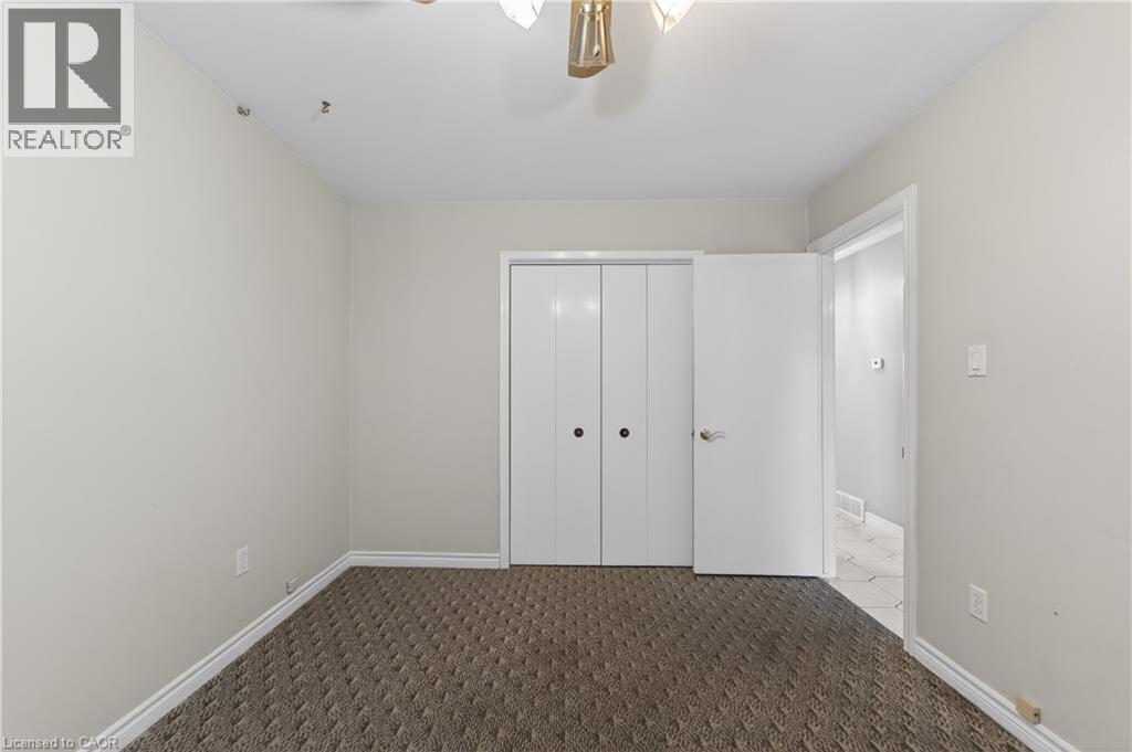 Unfurnished bedroom featuring carpet, a closet, and a ceiling fan