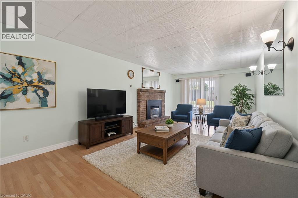 Living room with a fireplace and light wood-type flooring