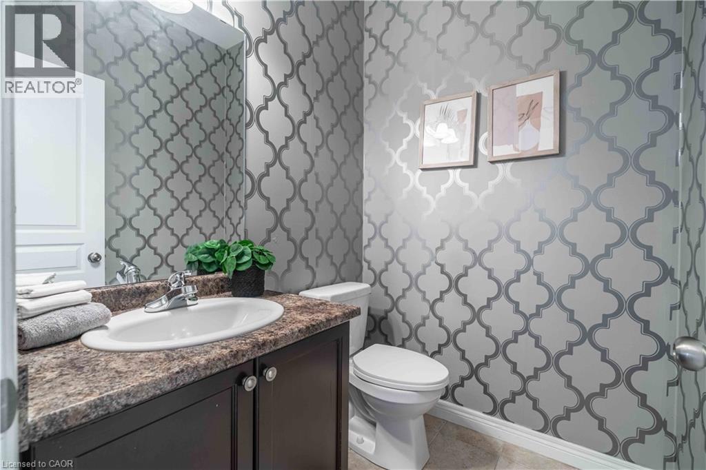Powder room on main level tucked away next to laundry area.