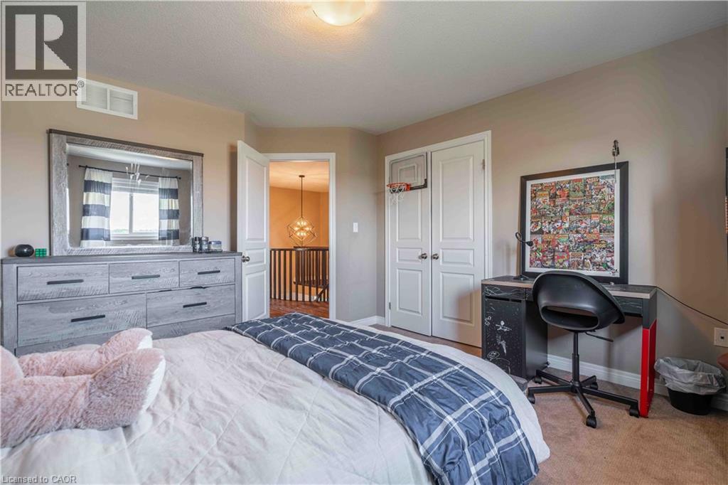 Child's Bedroom featuring carpet flooring, a closet, and a desk