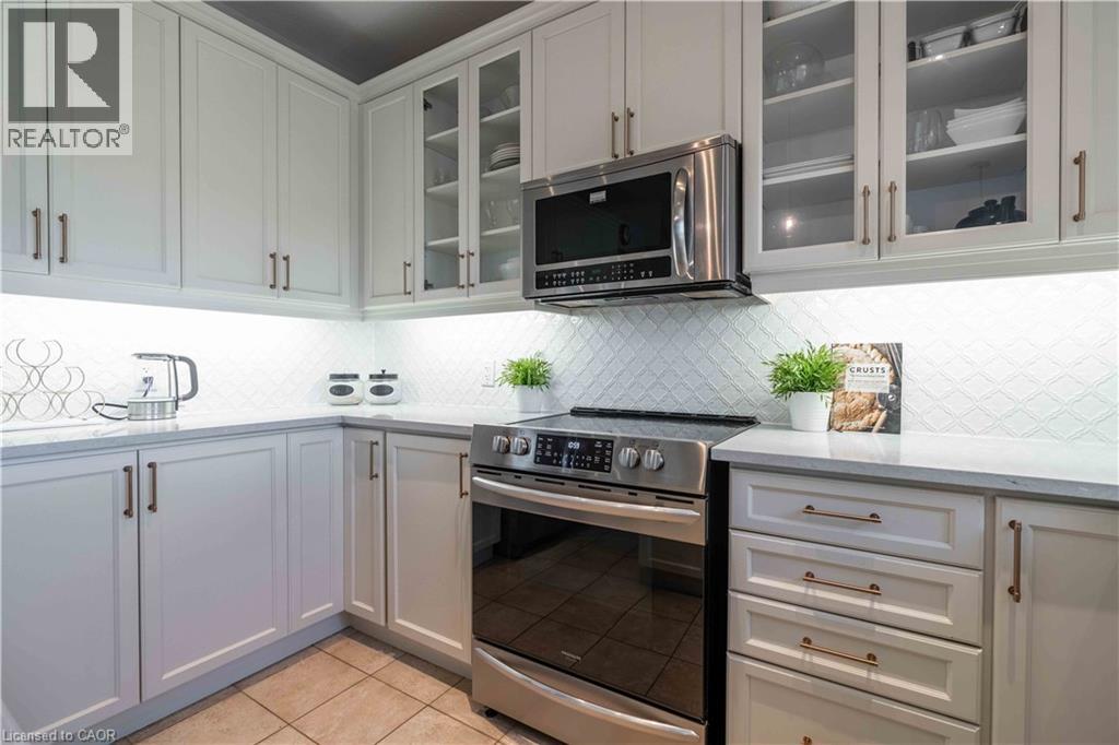 Note the tiled backsplash, slide-in gas cookstove and built-in Micro Oven.