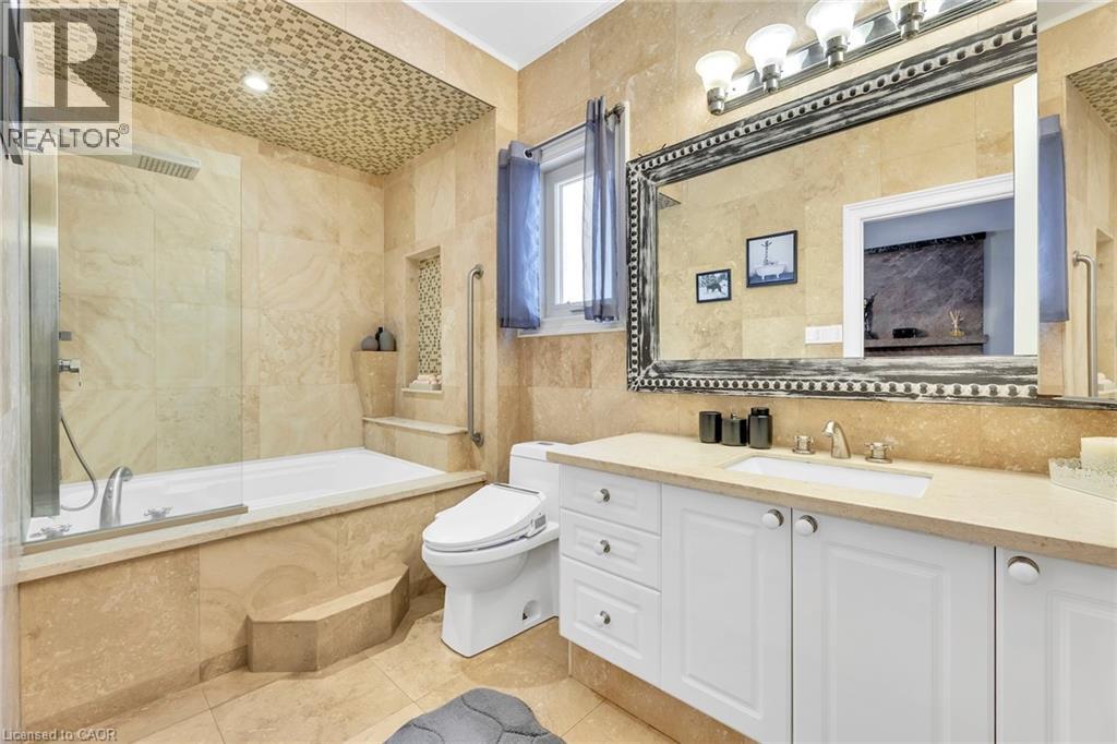 Bathroom featuring floor-to-ceiling natural stone wall and floor tile