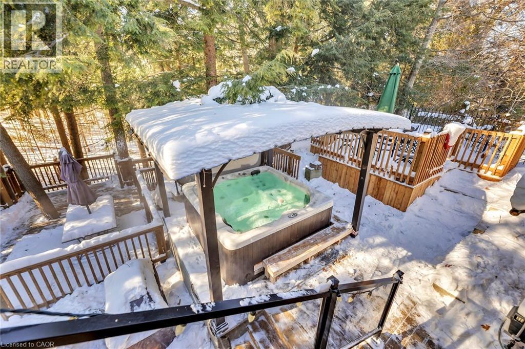 Outdoor spa area featuring a built-in hot tub with a protective canopy