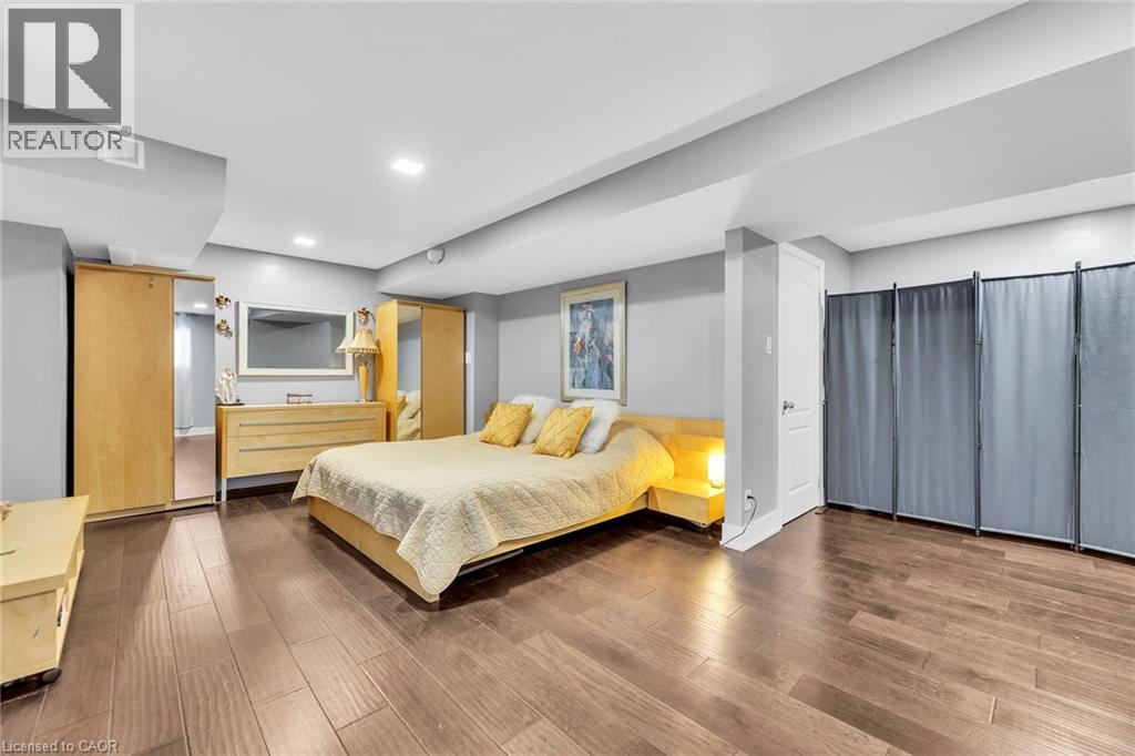 Spacious room featuring wood-finish flooring, recessed lighting, and light gray wall tones