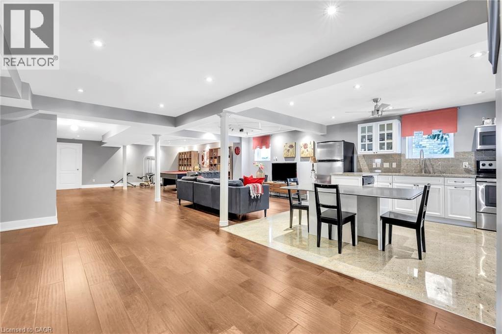 Open-concept lower level featuring wood-finish flooring, recessed lighting, and a full kitchen