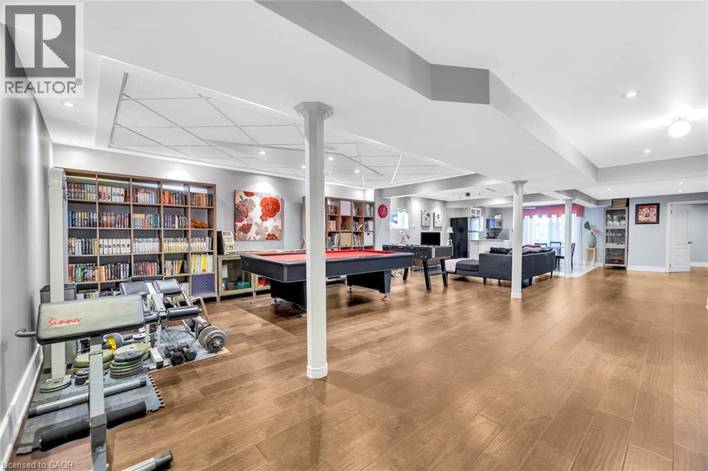 Expansive lower level featuring wood-finish flooring, recessed lighting, and support columns