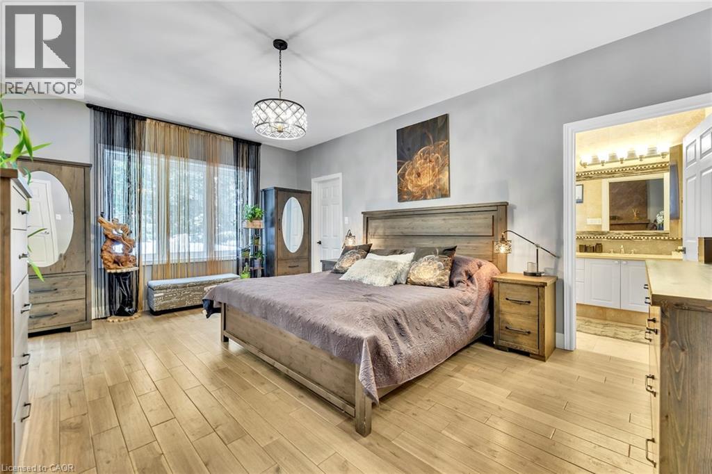 Spacious room featuring light wood-finish flooring and a central chandelier