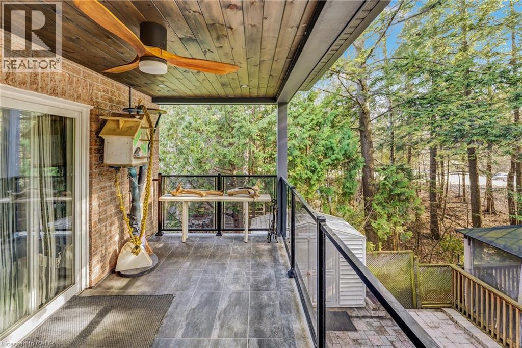 Covered outdoor patio featuring wood-finish ceiling, ceiling fan, and tiled flooring