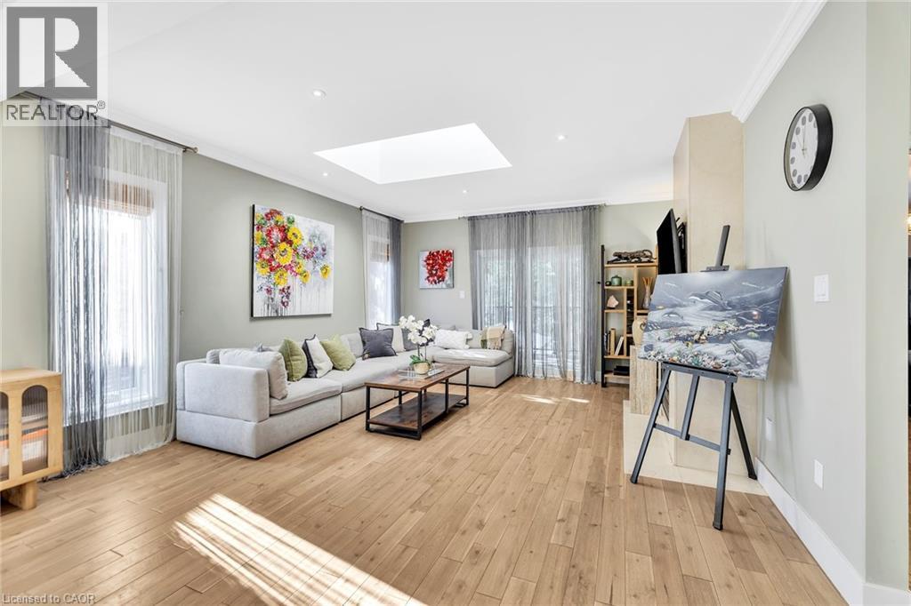 Spacious living area featuring light wood-finish flooring and a recessed lighting system