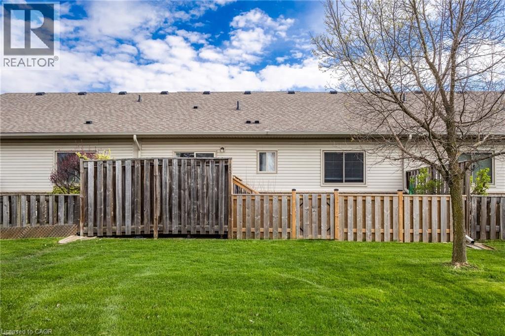 Expansive green lawn with a wood plank fence