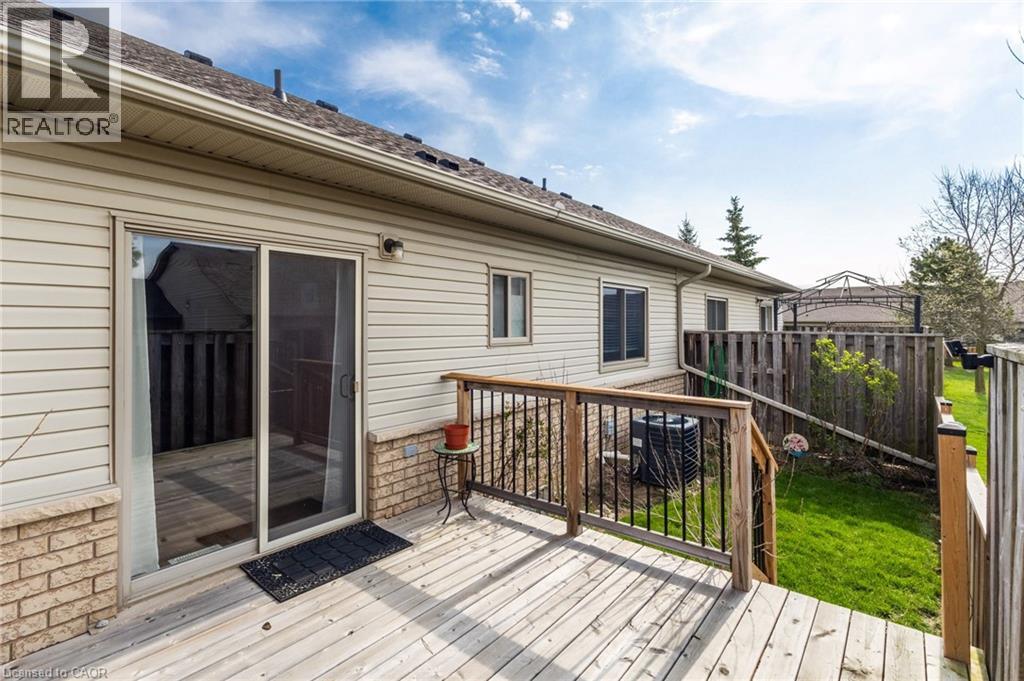 Spacious exterior deck with wood flooring and dark metal railings