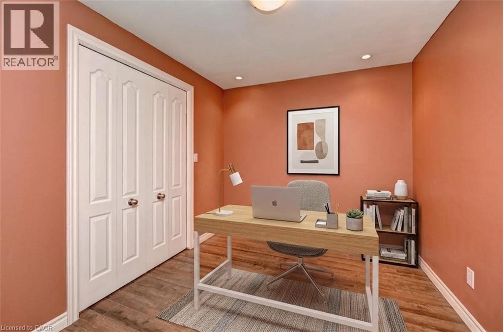 Room featuring wood-finish flooring, recessed lighting, and a closet with bifold doors