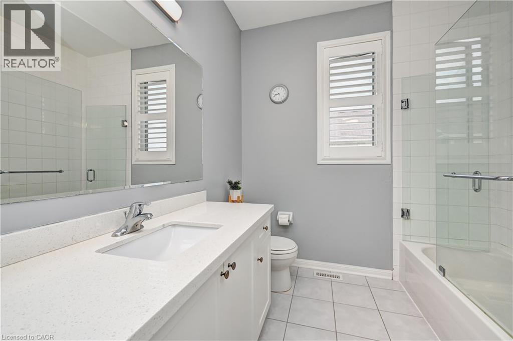 Bathroom featuring a white vanity with an integrated sink, polished chrome faucet, and a large wall-mounted mirror