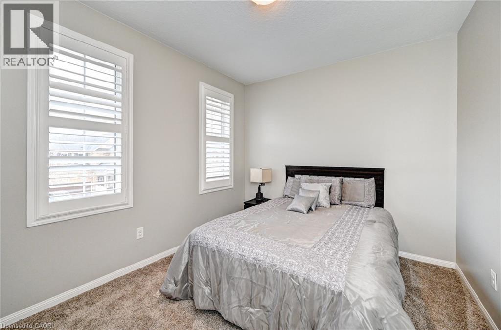 Bedroom with neutral wall paint and plush carpet flooring