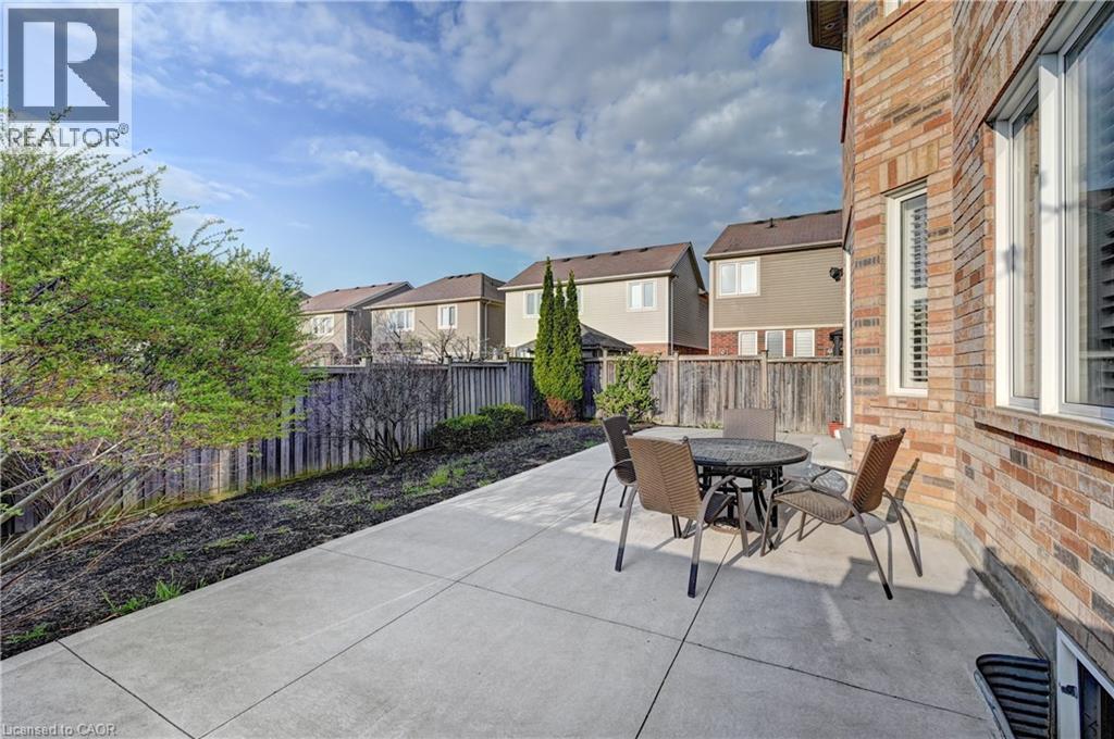 Expansive concrete patio area offering direct access to the brick-clad exterior