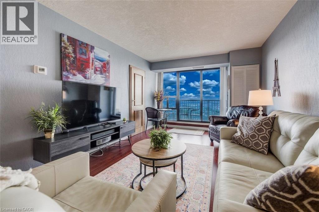 Living area with wood finished floors and a textured ceiling