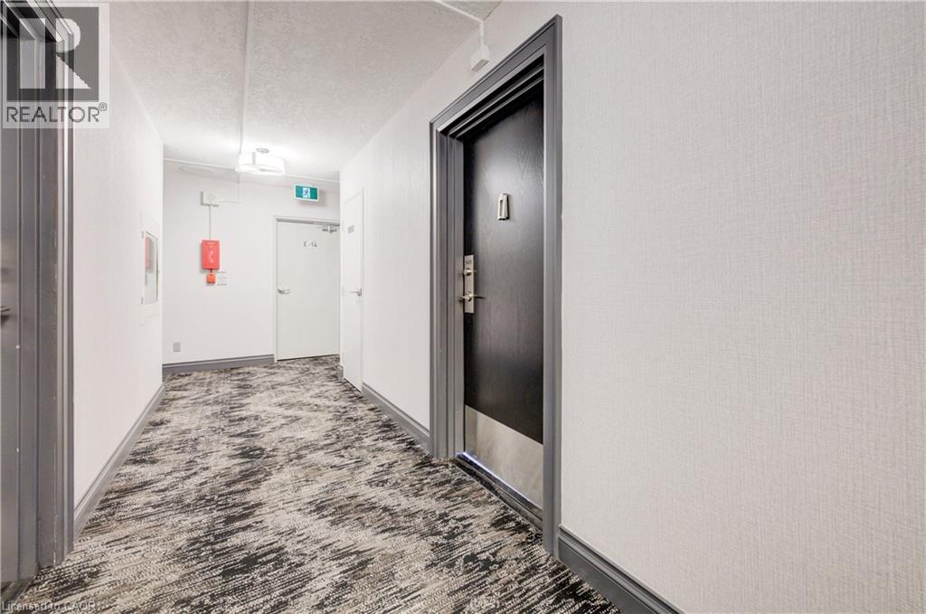 Hall with carpet flooring and a textured ceiling