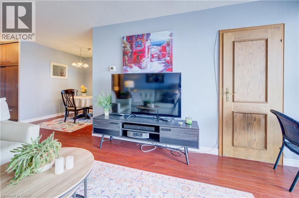 Living room featuring wood finished floors and hanging lights