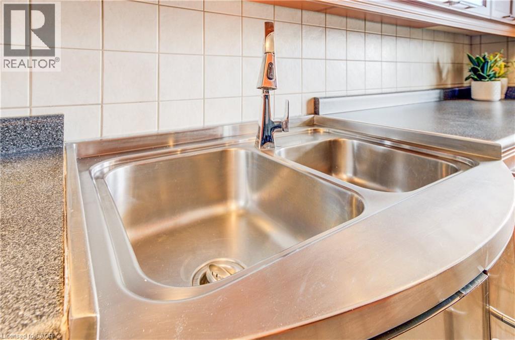 Kitchen view of decorative backsplash and a sink