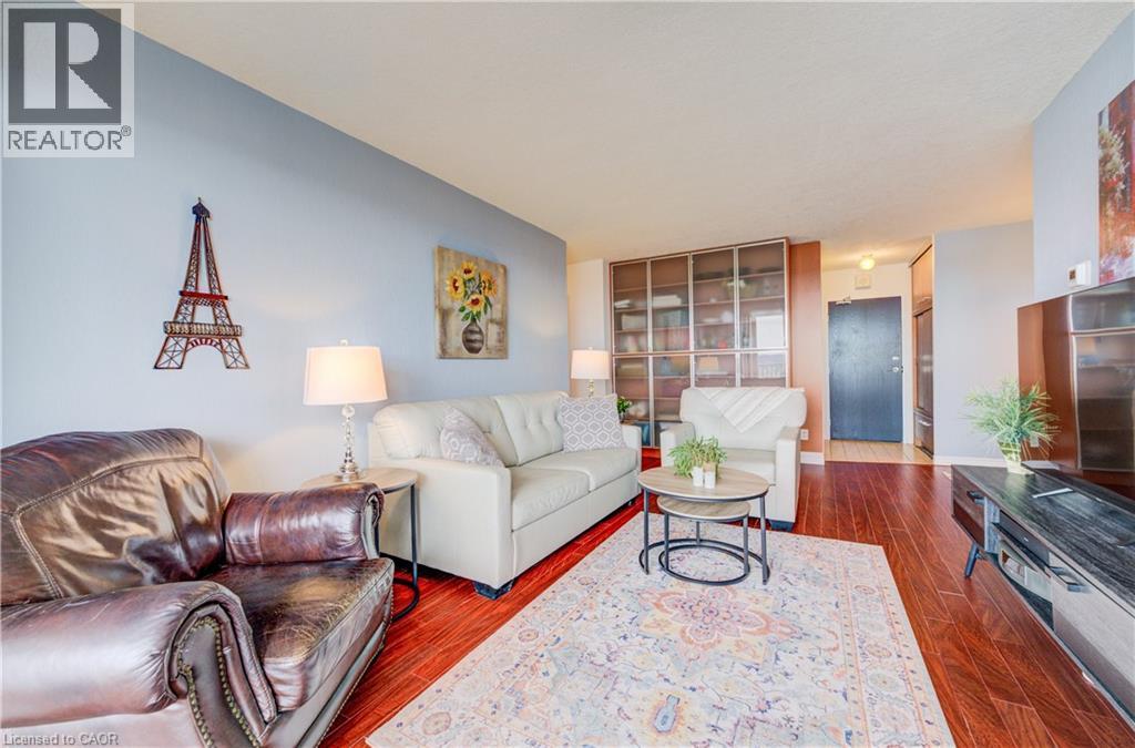 Living room with dark wood-style flooring and baseboards