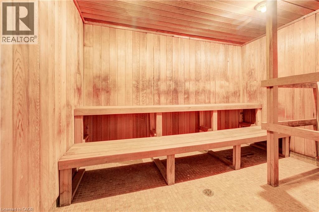 Relaxing sauna featuring wood ceiling and wooden walls