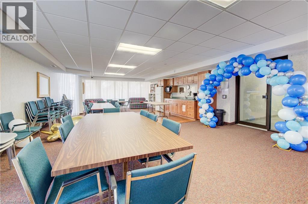 Dining area featuring a paneled ceiling and carpet flooring