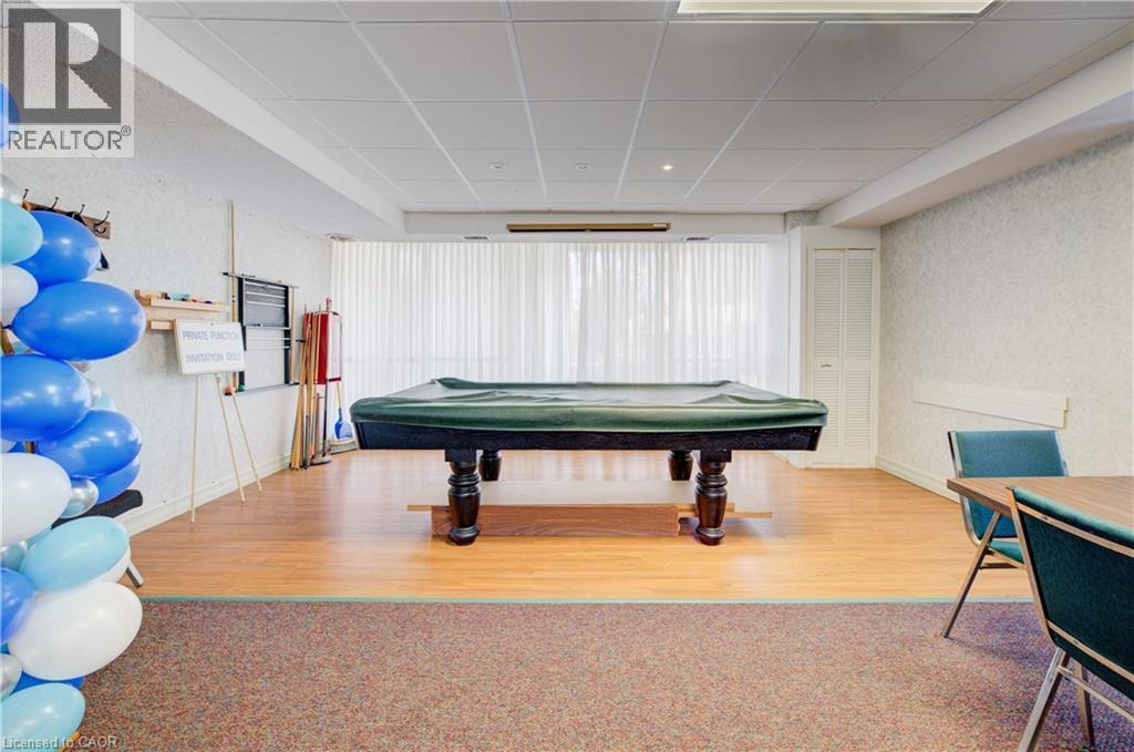 Recreation room featuring billiards, a paneled ceiling, and wallpapered walls
