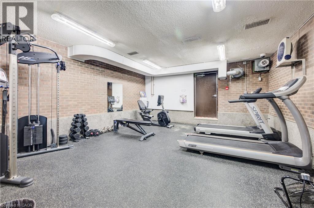 Workout area with a textured ceiling and brick wall
