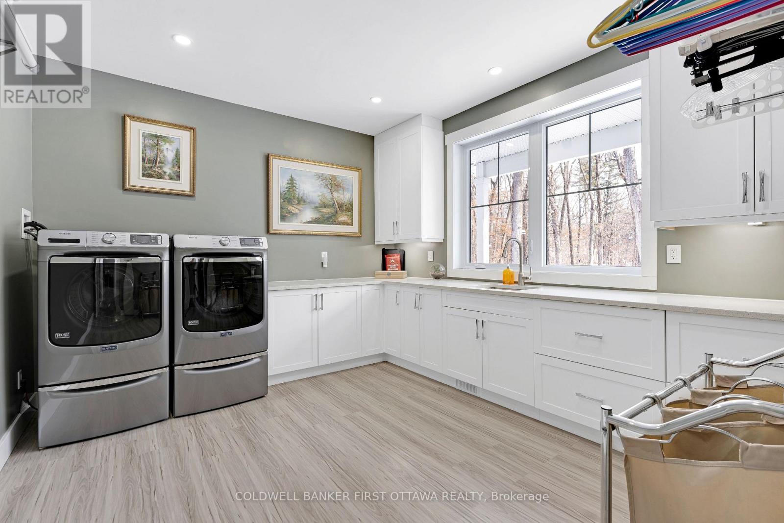 Main floor amazing laundry room; quartz cabinets