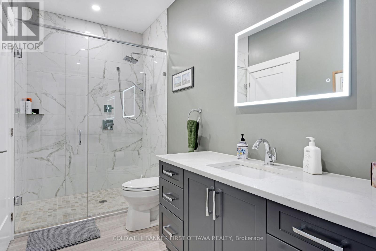 Main bathroom quartz vanity & glass shower