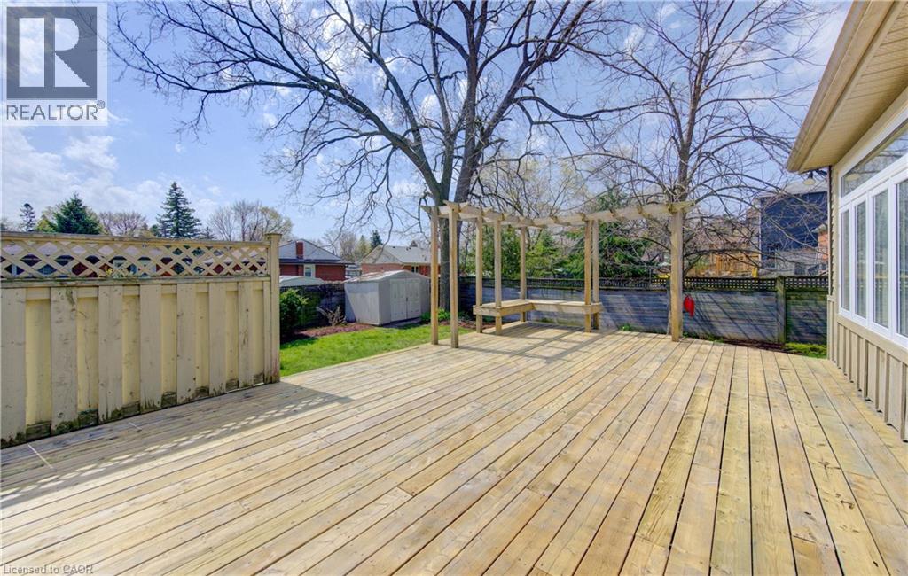 Expansive wood deck with a built-in pergola and bench seating
