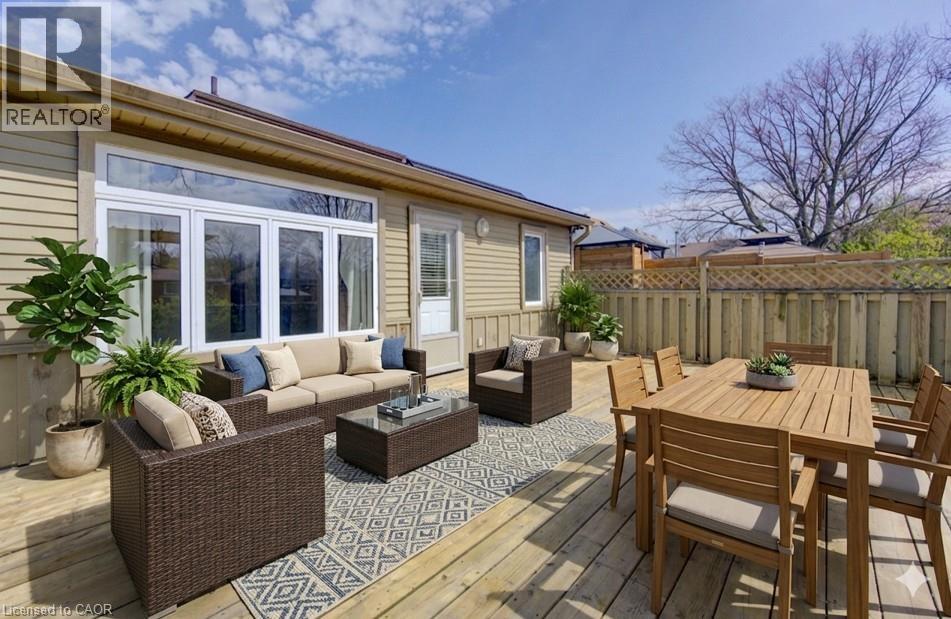 Expansive wood deck with a full-height privacy fence and horizontal siding exterior