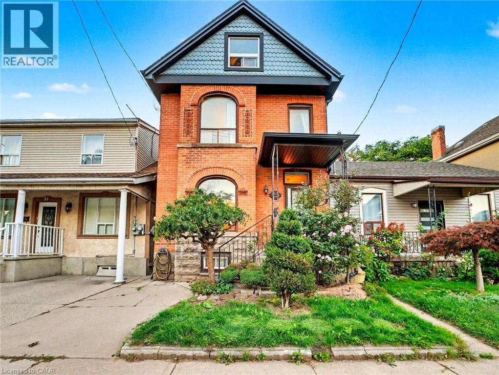 Victorian house with brick siding and a porch