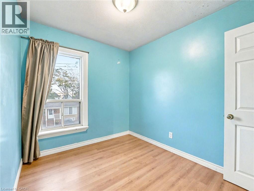 Unfurnished room with light wood finished floors and baseboards