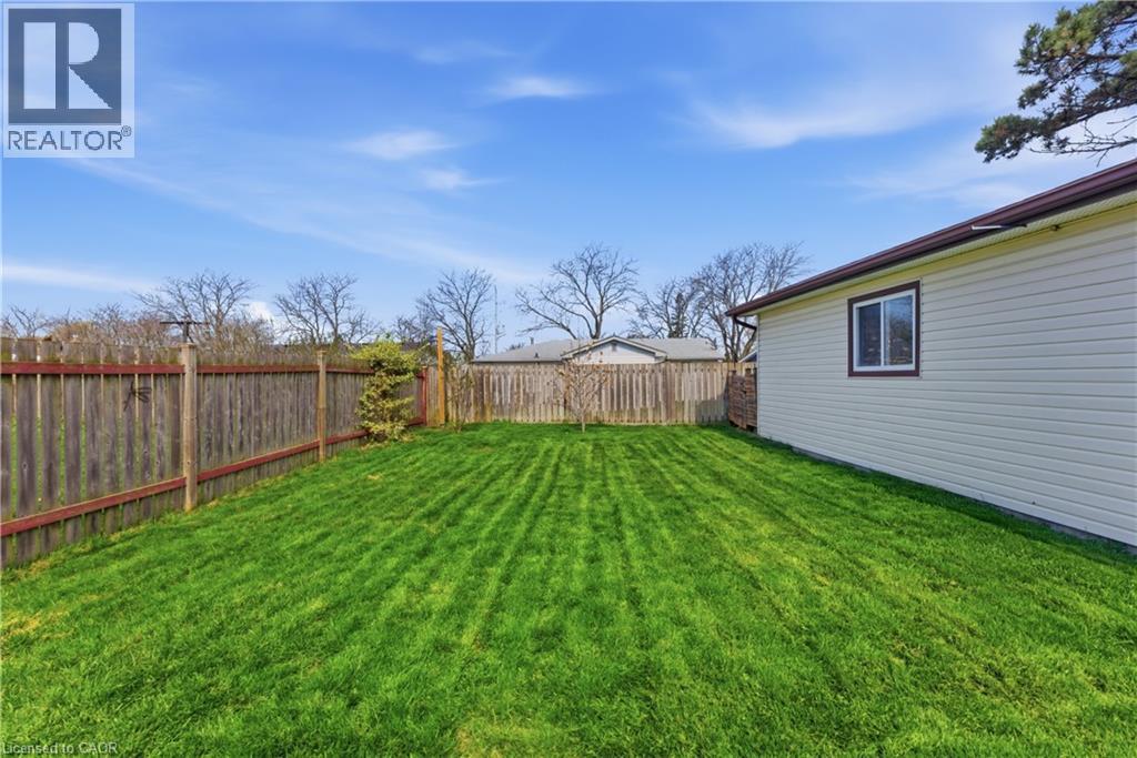 Expansive green lawn surrounded by a wood privacy fence