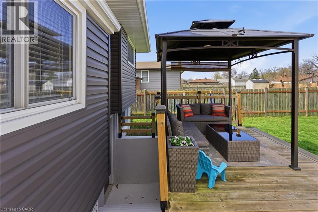 Expansive outdoor deck featuring a dark metal gazebo, offering a dedicated covered area