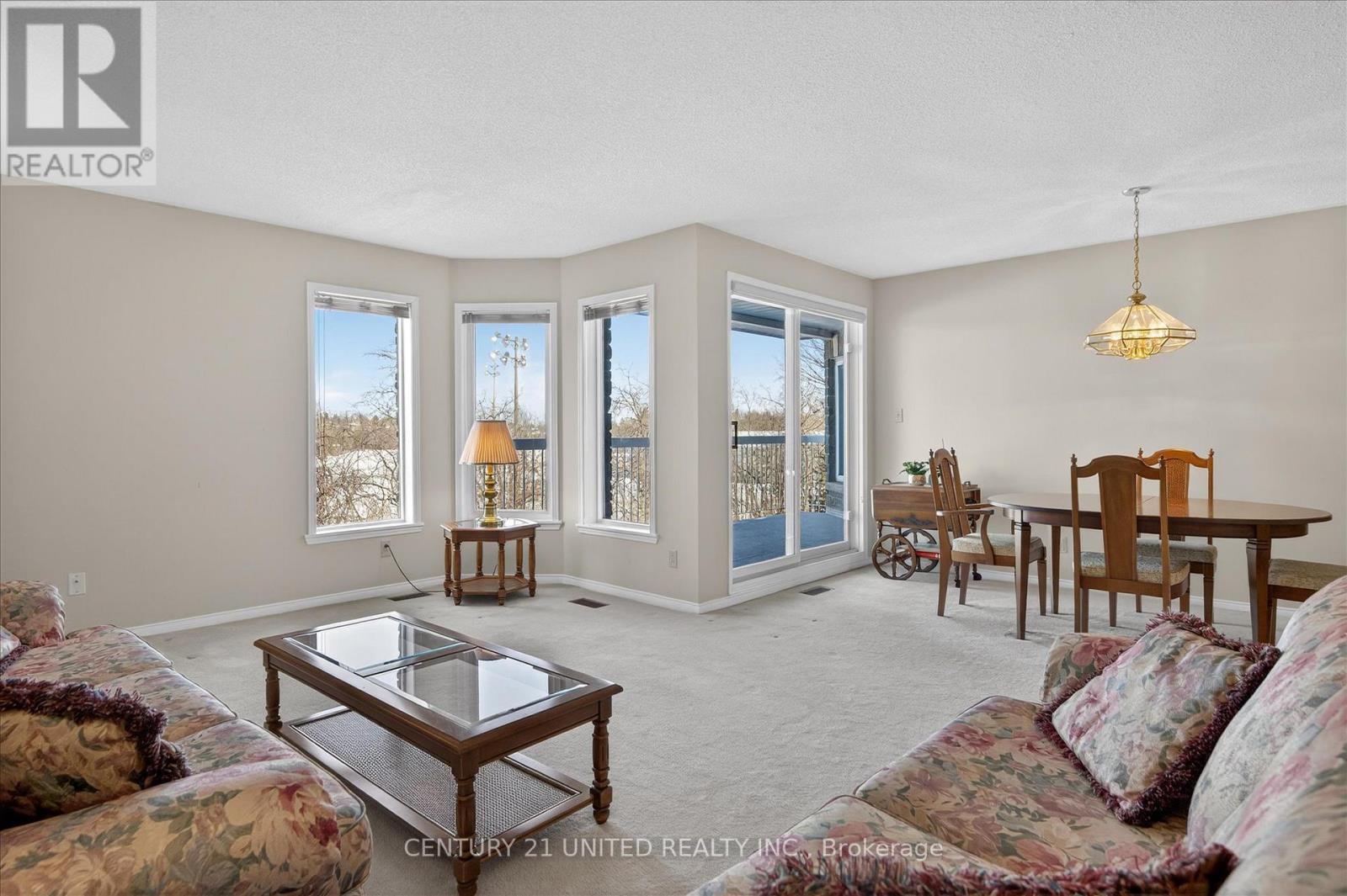 sun-filled living and dining room with walkout