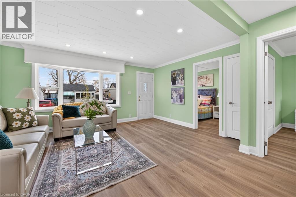 Bright living space featuring wood-finish flooring and recessed lighting