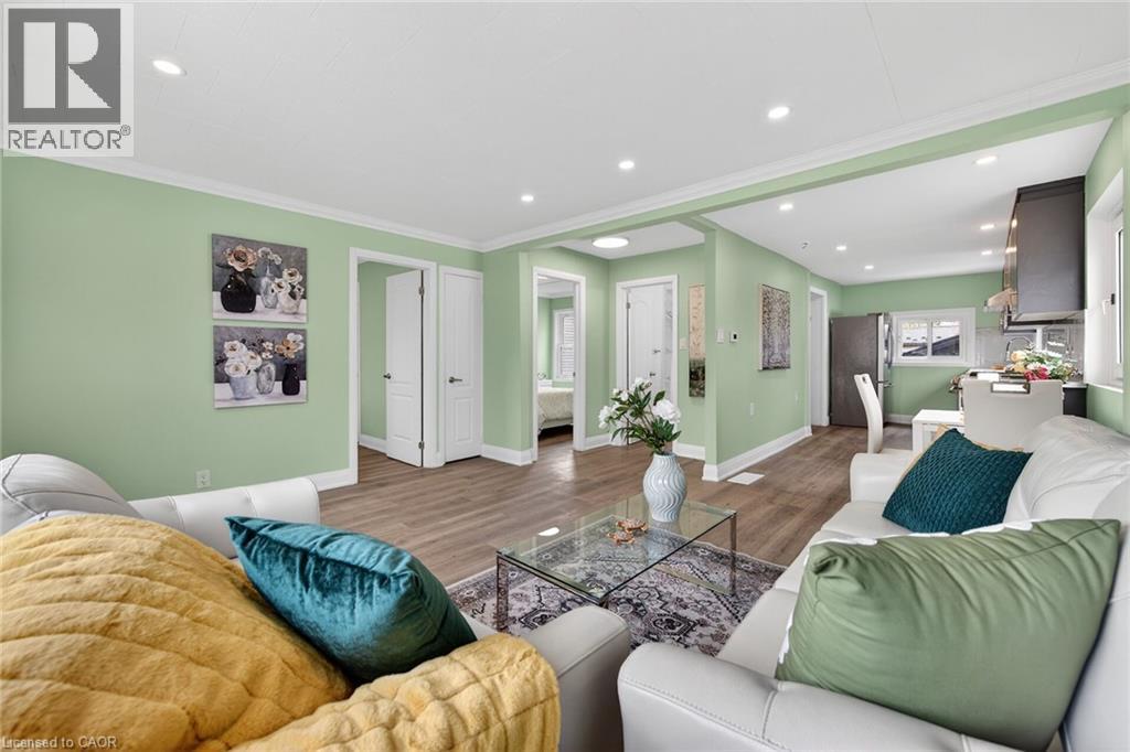 Open-concept living area with recessed lighting and crown molding