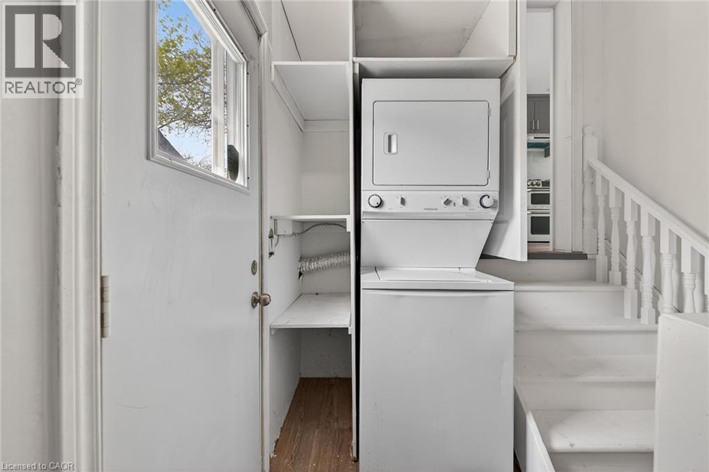 Dedicated laundry area featuring a stacked washer and dryer unit