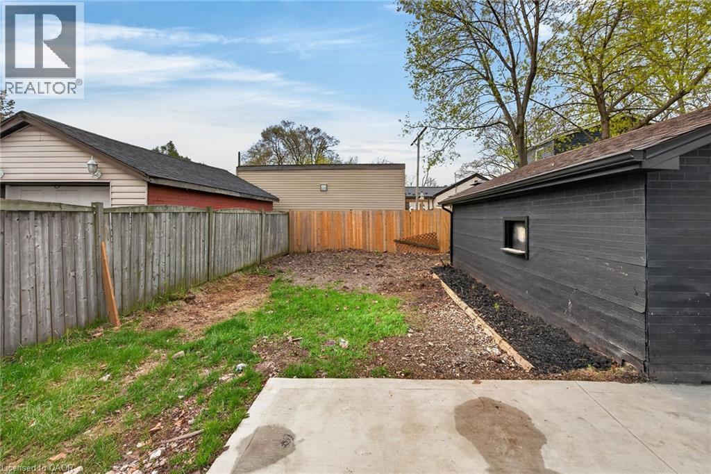 Concrete patio area extending to a yard space