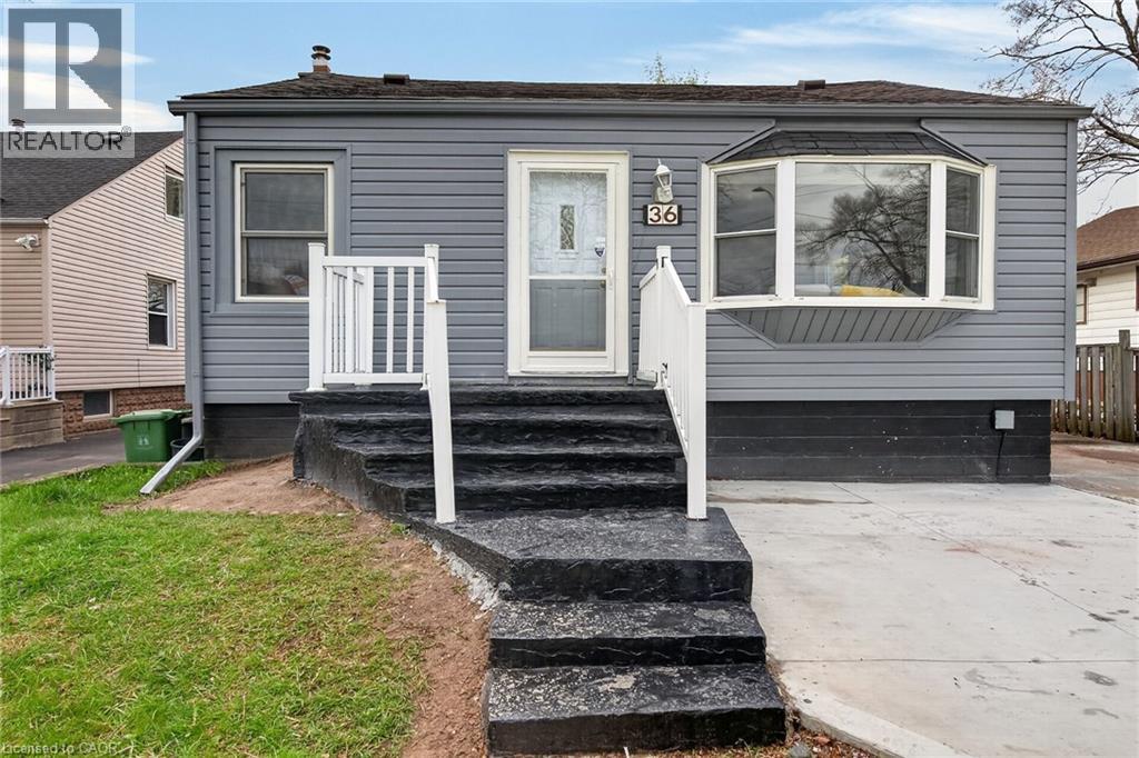 Gray siding exterior with a bay window and a concrete driveway