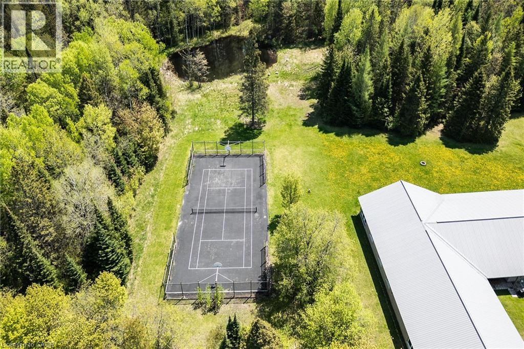 Fenced asphalt court with tennis and basketball markings
