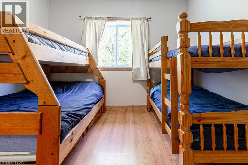 Naturally finished wood bunk beds with built-in storage drawers, set on wood-finish flooring